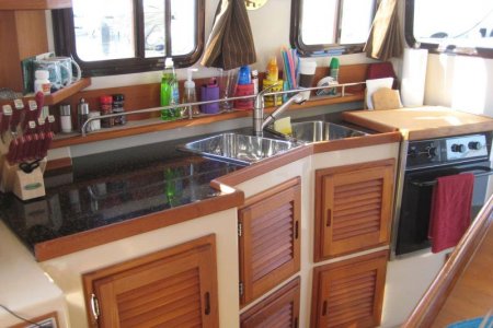 Kitchen with custon cutting board over gas stove