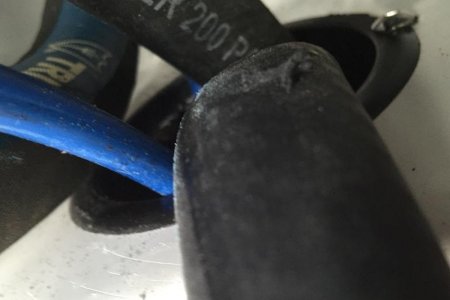 Damaged hoses caused from freely chafing against each other in access hole