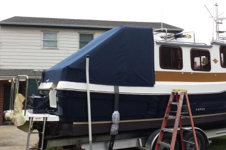 Canvas cockpit cover keeps canvas frame out of the weather and cockpit dry