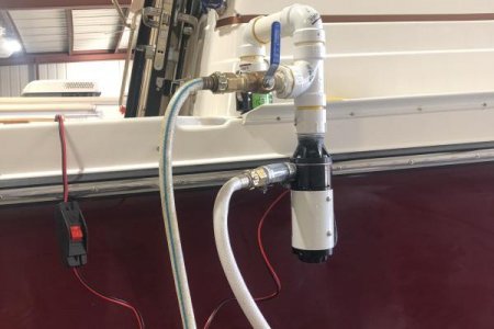 Pump mounted on quick coupler on Ranger.