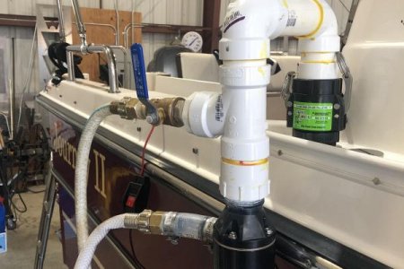Top hose is water inlet for rinsing and bottom is discharge of black water.