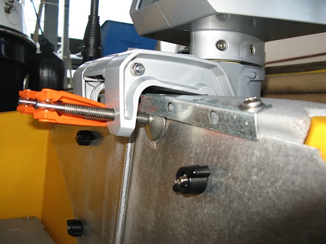 C-clamp cups located UNDER the steel bracket.