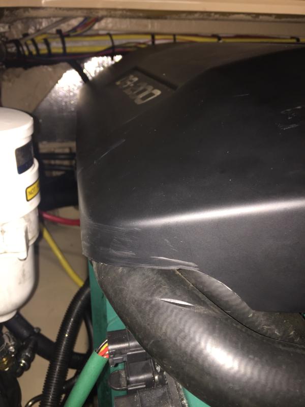 Cover cutout to stop coolant hose chafing