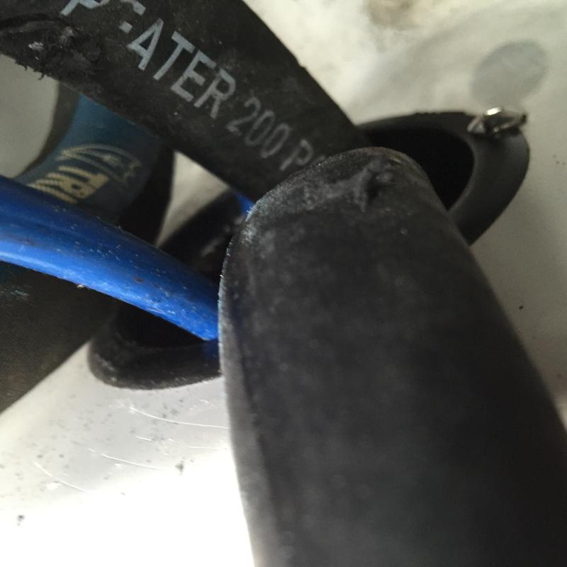 Damaged hoses caused from freely chafing against each other in access hole
