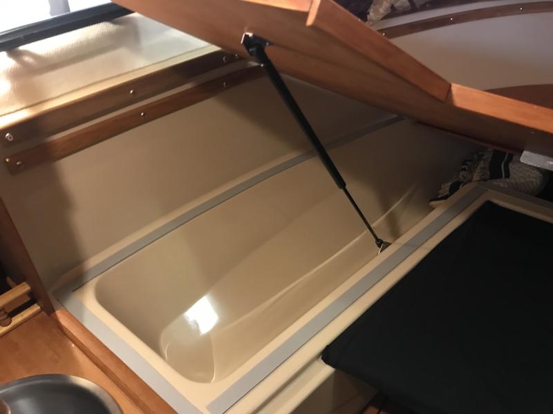 Gas Struts to assist.  Teak trim to finish. Camper Seal to silent.
