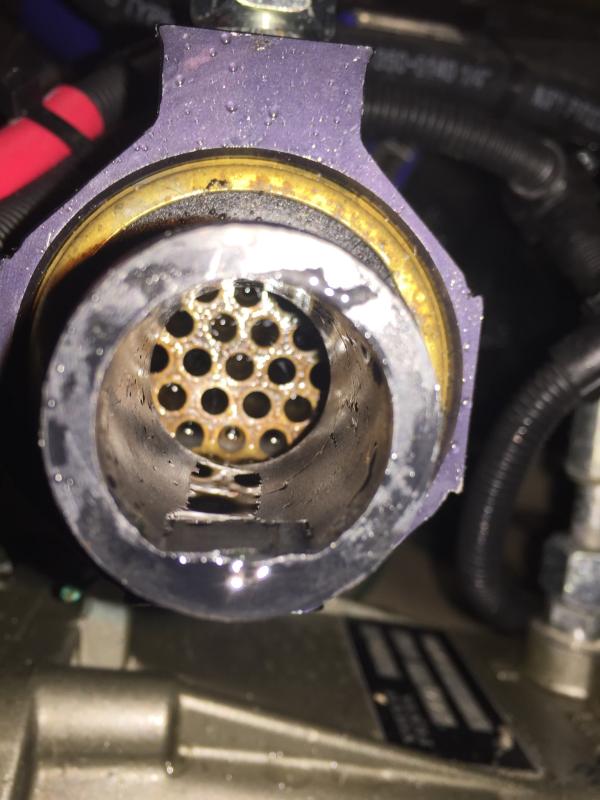 Inlet (starboard side) of transmission cooler after flushing from outlet side.