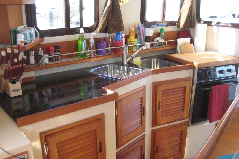 Kitchen with custon cutting board over gas stove