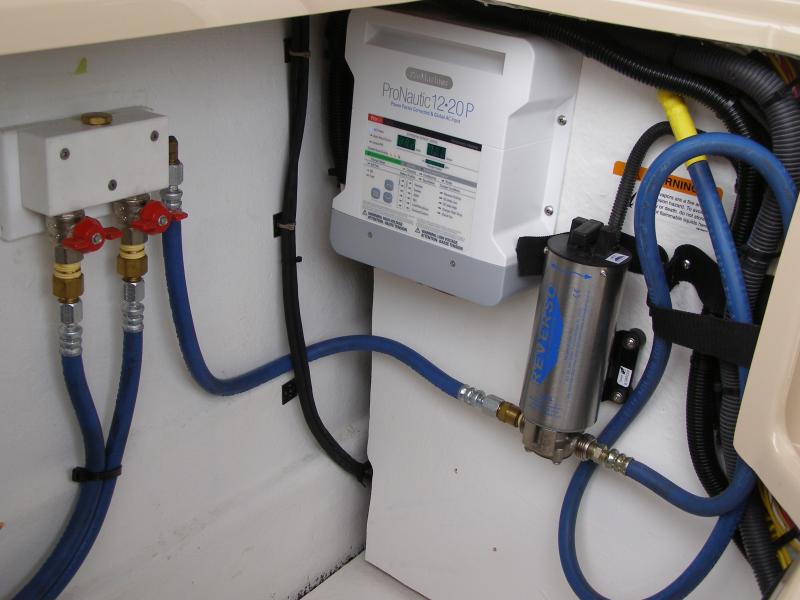 oil change system, relocation battery charger to port cockpit locker