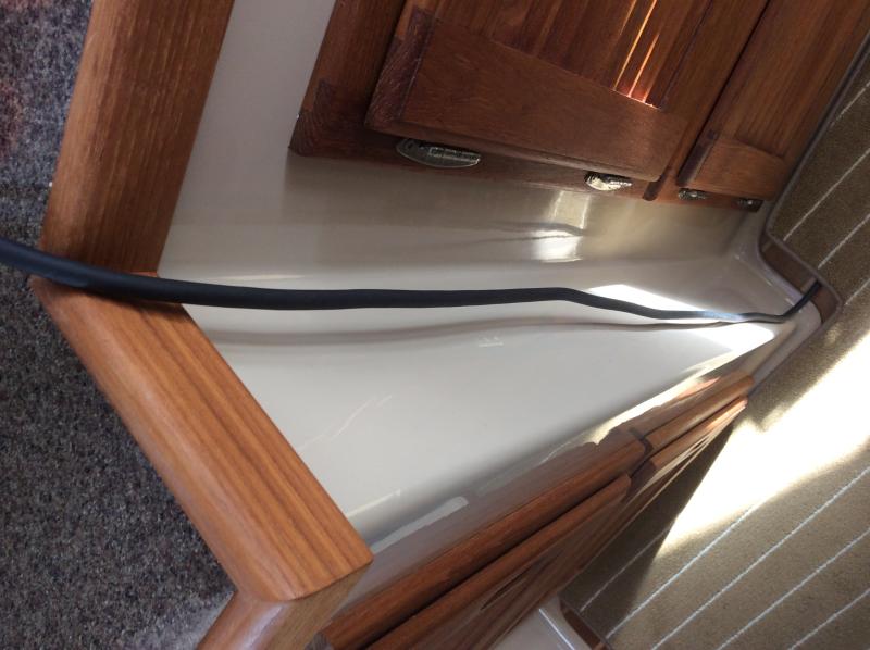 Power cord routed from floor compartment