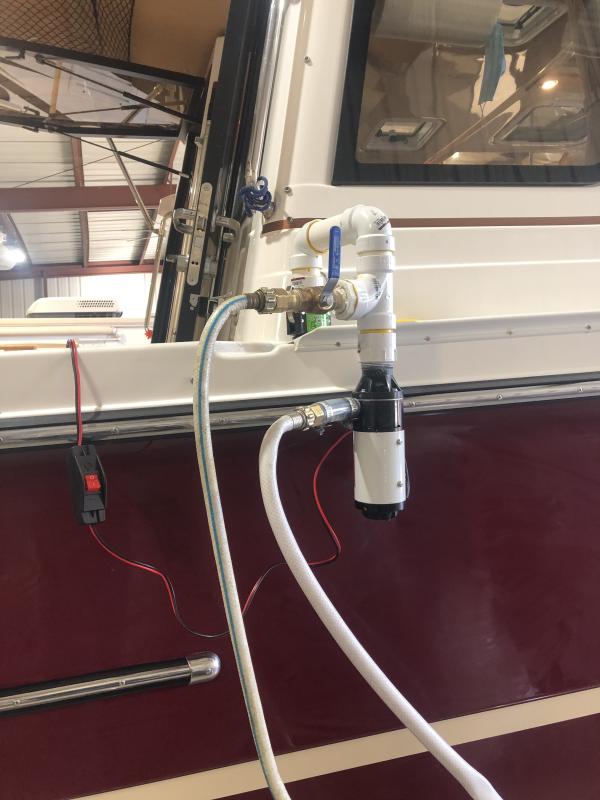 Pump mounted on quick coupler on Ranger.
