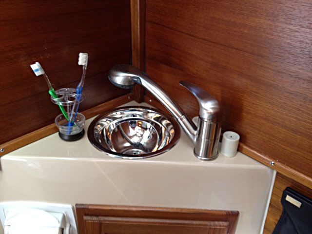 Showerhead with shut-off, toothbrush holder