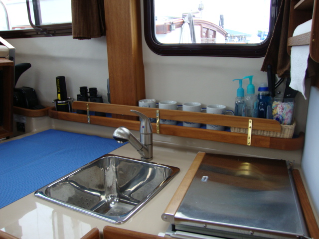 Teak fiddles added at sink
