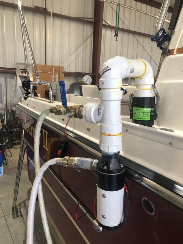 Top hose is water inlet for rinsing and bottom is discharge of black water.